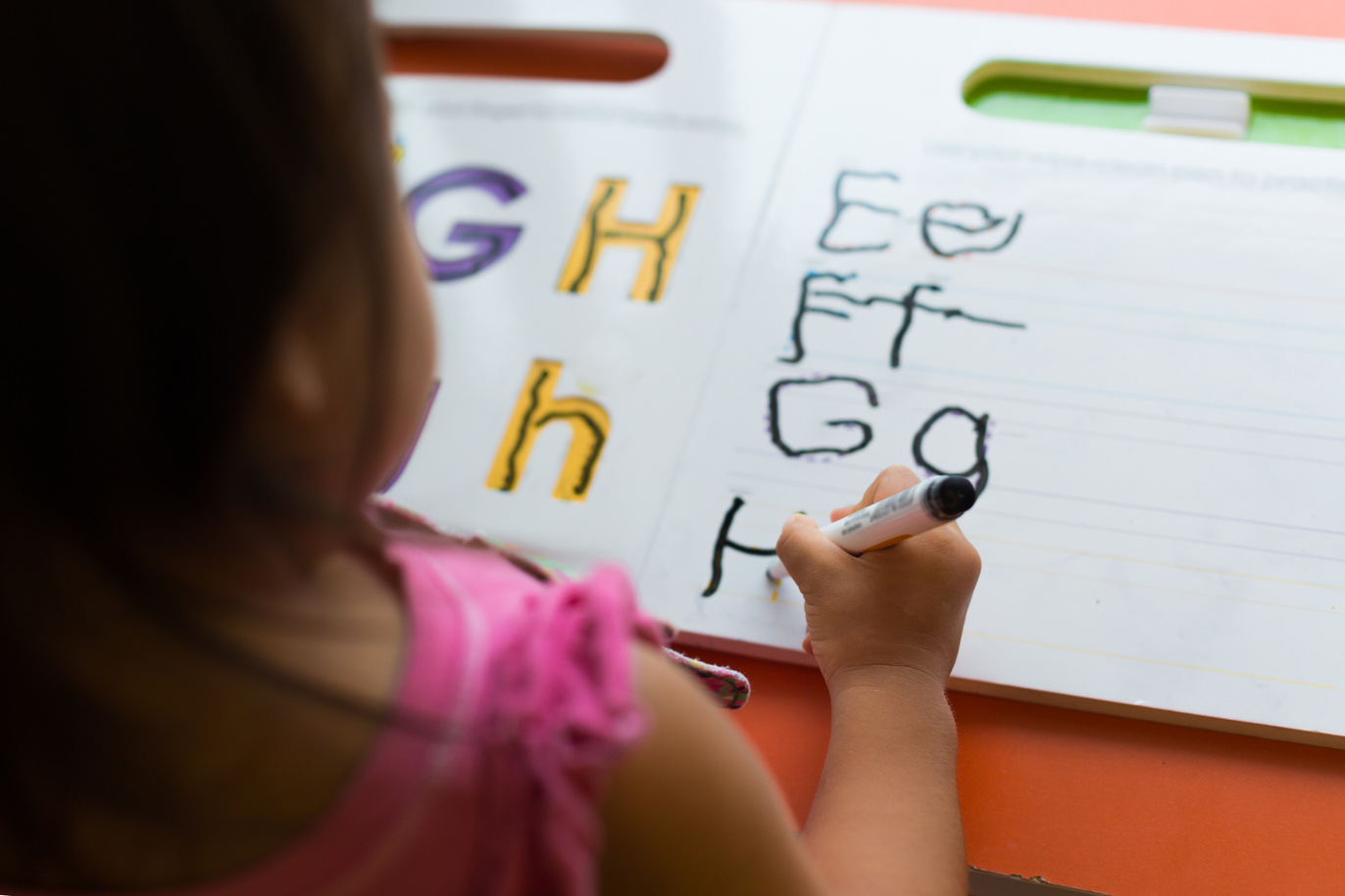 kids learning how to write the abc's at home.